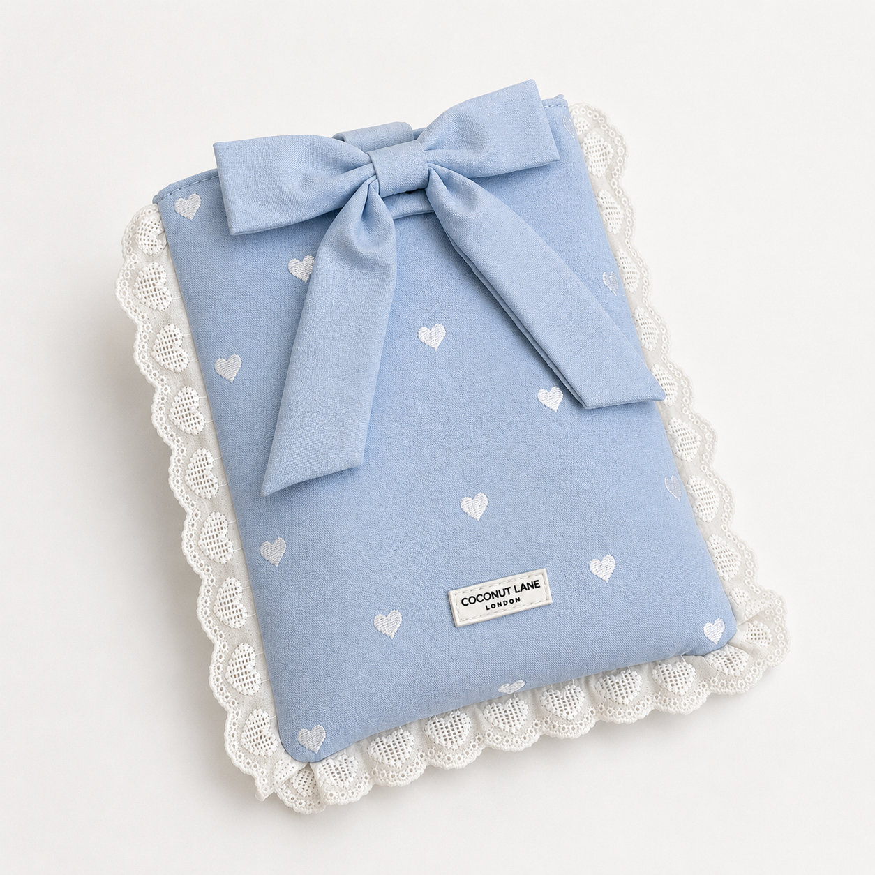 Blue fabric Book Sleeve with embroidered heart design, bow closure and white lace edging.