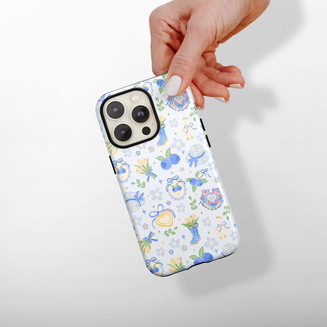 Phone case with floral pattern held by a hand on a light gray background