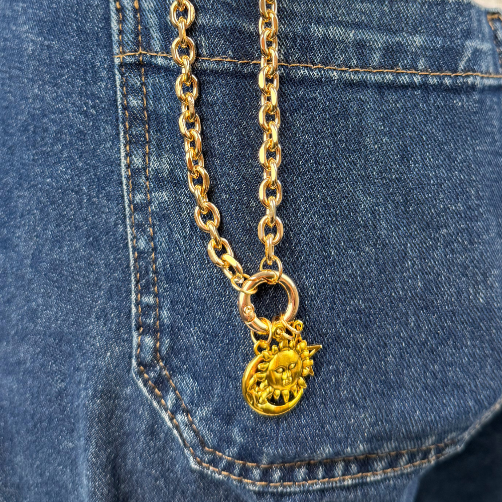 Sun charm on strap in jean pocket