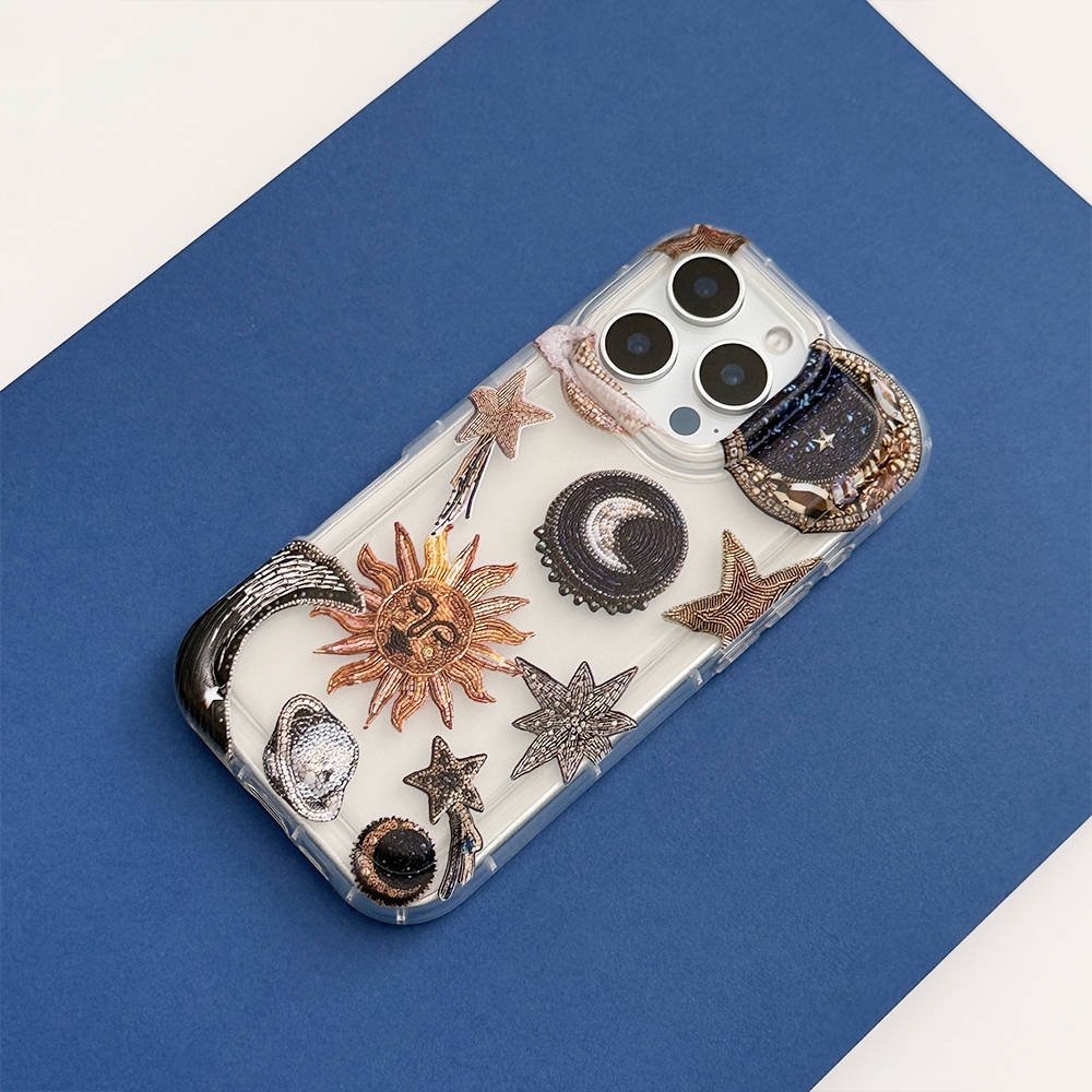 Clear Coconut Lane phone case on iPhone with blue and white celestial design of sun, moon, and stars.