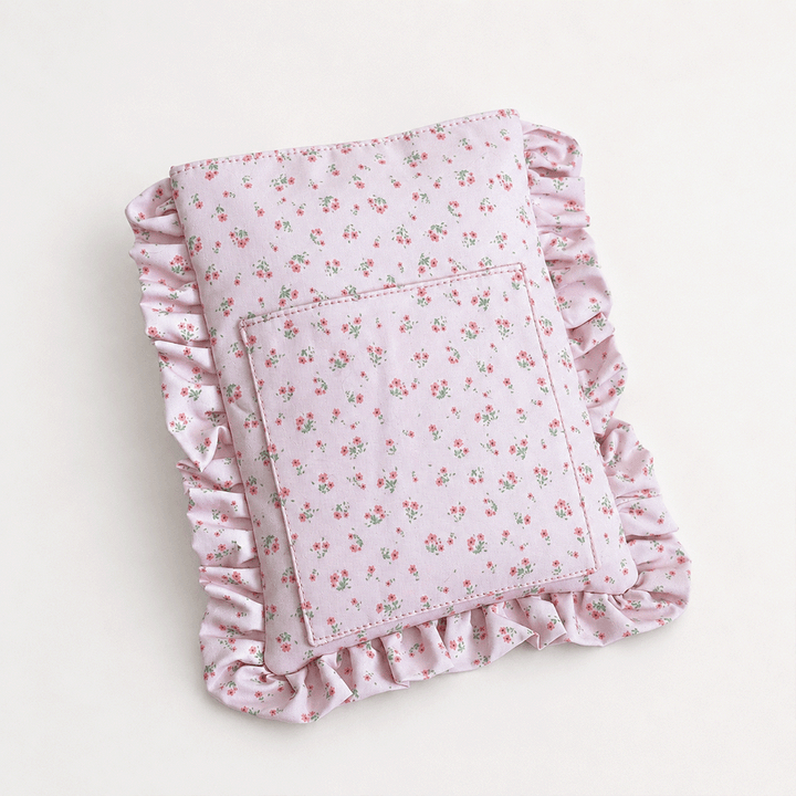 Pink floral patterned Book Sleeve with ruffled trim.