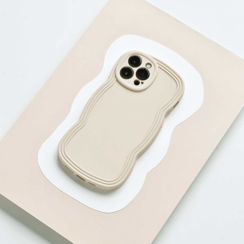 Flatlay style image of cream phone case with wavy edges.