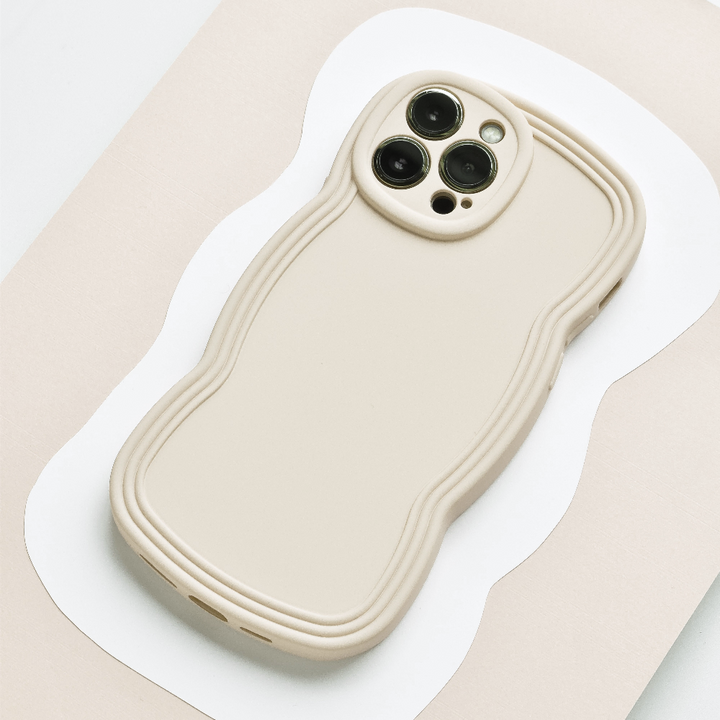 Flatlay style image of cream phone case with wavy edges.