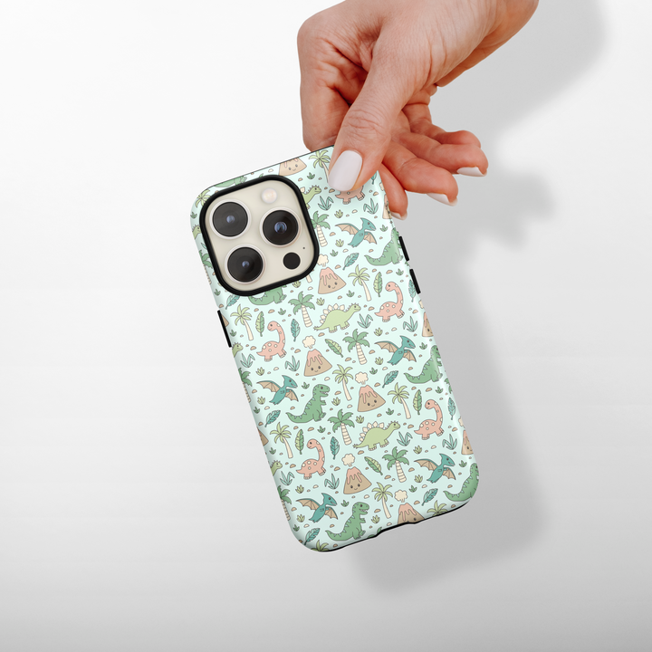 Phone case with dinosaur pattern held by a hand on a light background