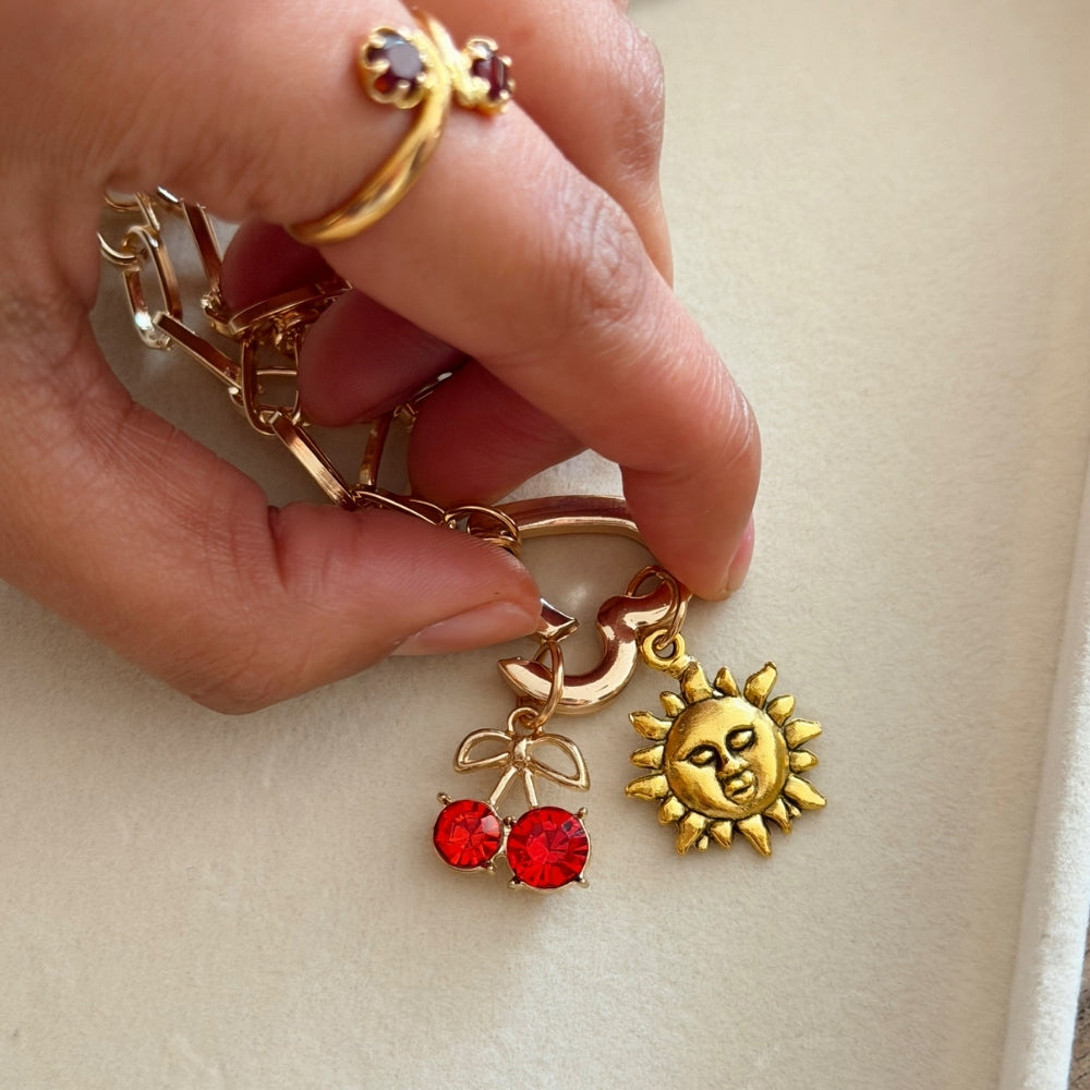 Heart clasp being opened to add charms onto phone strap chain