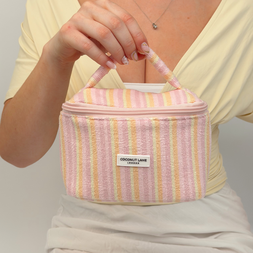 Girl holding Mini Vanity Case - Pastel Stripes by handle