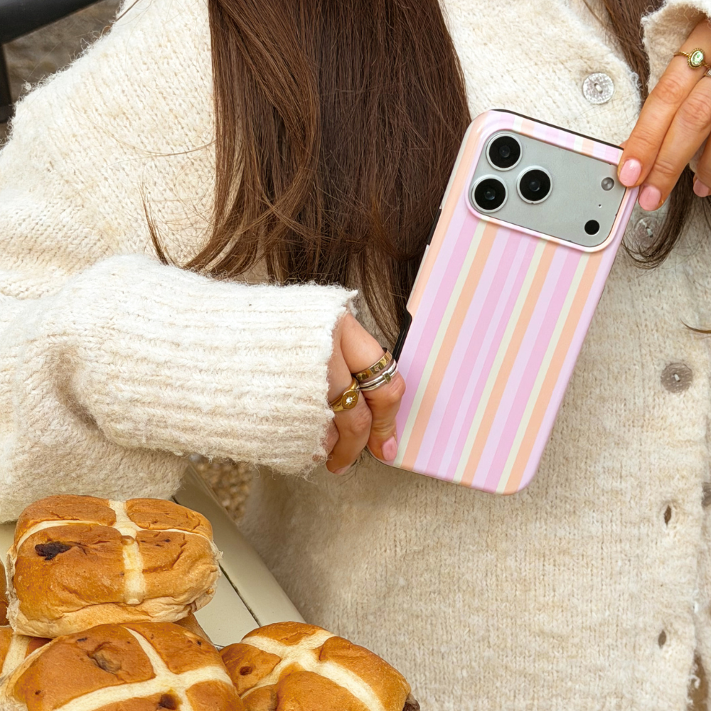 Girl holding pastel stripes phone case close up