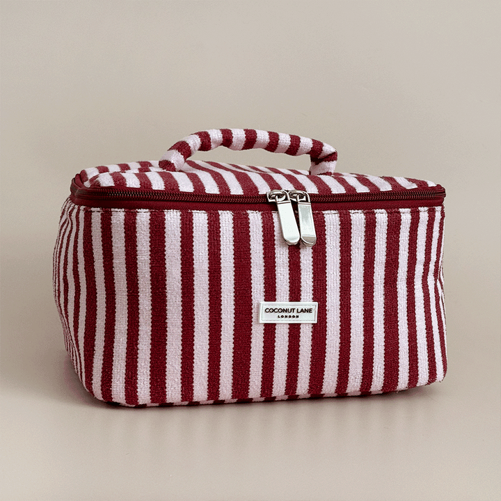 Burgundy and light pink striped Vanity Case, with handle, silver zip and Coconut Lane logo badge.