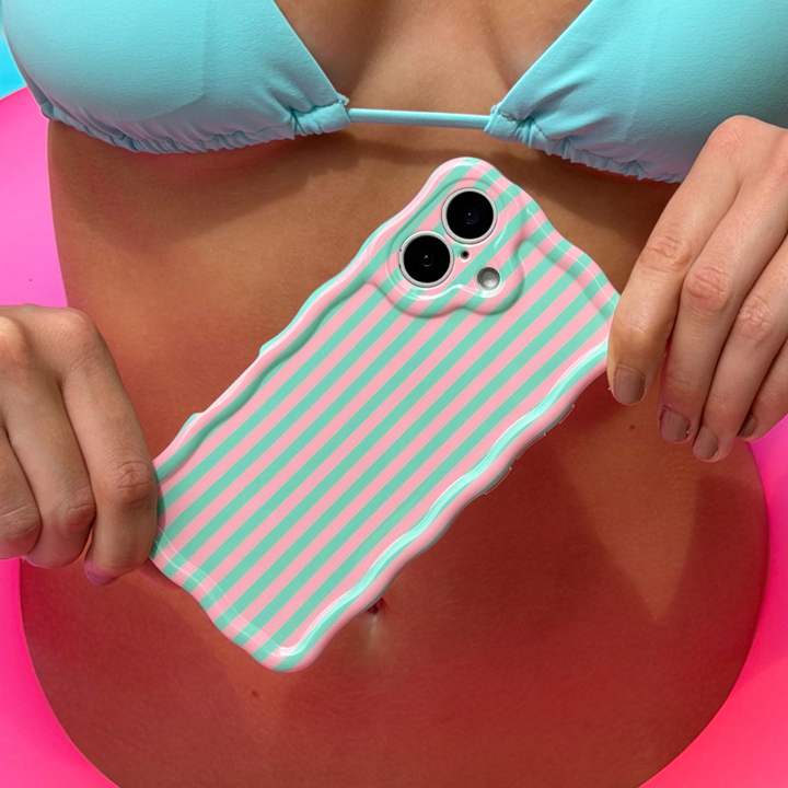 Girl holding a wavy phone case with pink and green stripes, wearing a turquoise bikini.