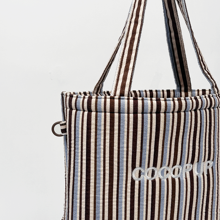Brown and blue striped tote bag with COCOPUP embroidered on the front.