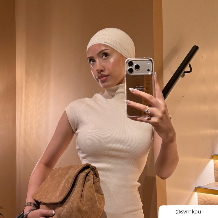 woman taking a selfie holding a mirror phone case, with the text "It's not that deep" printed on the back in small font.