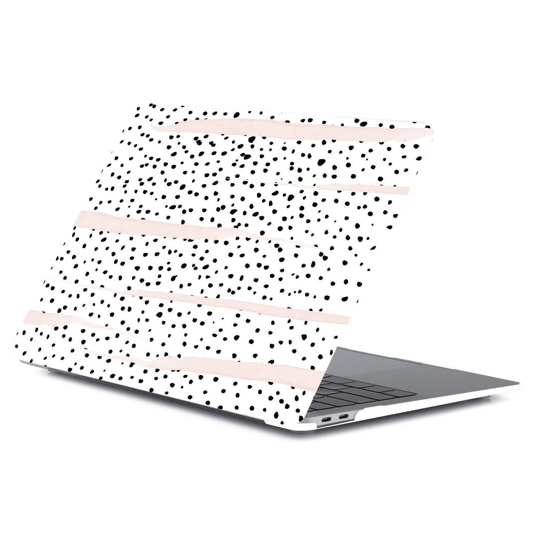 black and white dalmatian print with pink brush strokes on a macbook with white background