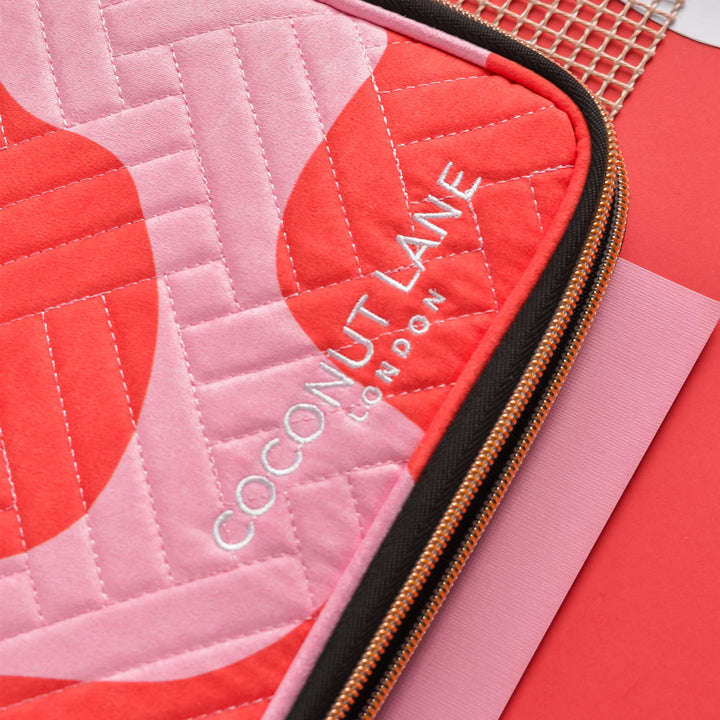 Close up of Coconut Lane branding on Pink & Red Abstract design matte velvet Watch Strap Travel Case.