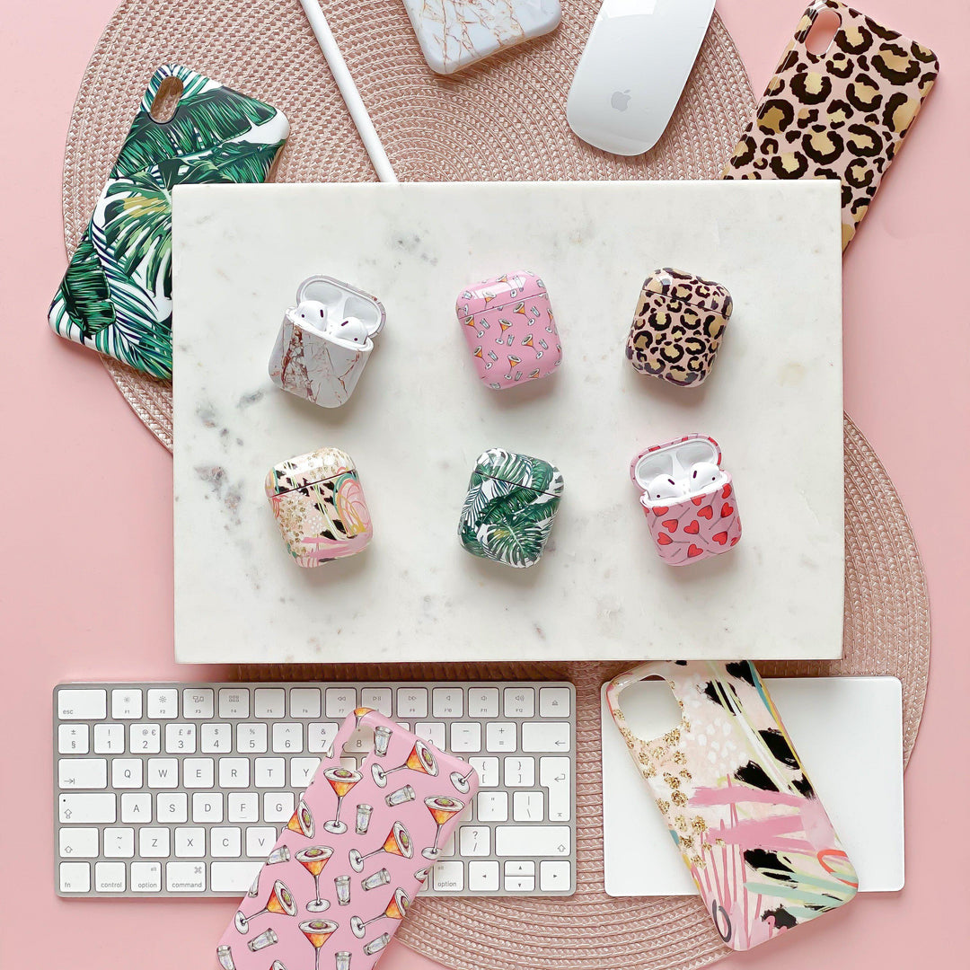 Coconut Lane's six Airpod cases with matching phone cases on pink background