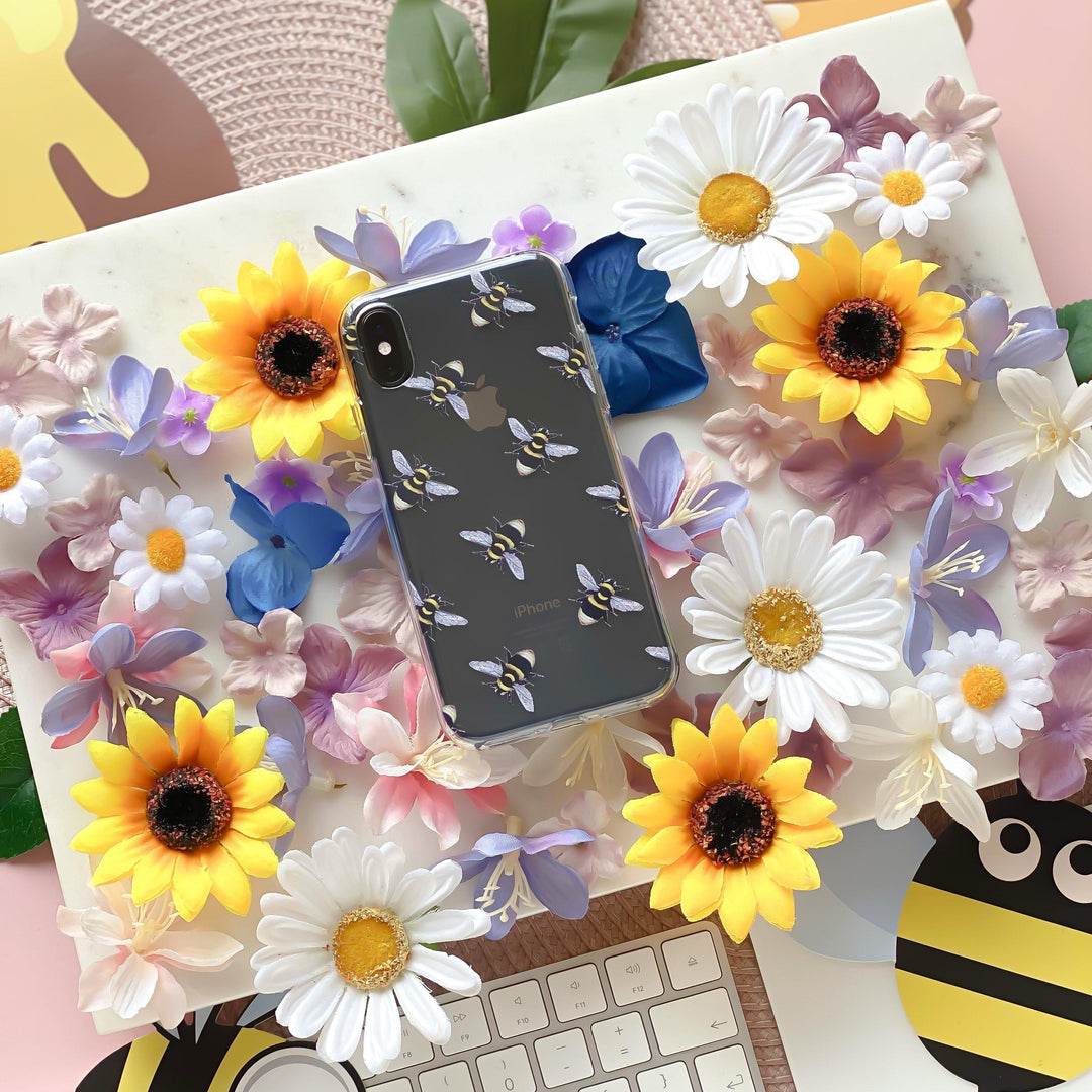 Bee Clear Phone Case surrounded by flowers and bees